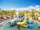 Waterpark with a splash pad including slides, fountains and a palm tree lined pool deck area at 14501 Grove Resort Grove Resort Ave # 3733, Winter Garden, FL 34787