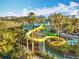 Waterpark featuring a vibrant yellow and green water slide surrounded by lush tropical landscape at 14501 Grove Resort Grove Resort Ave # 3733, Winter Garden, FL 34787