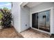 Back patio with sliding glass door, brick floor, and a view of the yard at 149 E Muriel St, Orlando, FL 32806