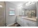 Bathroom with white cabinets, granite countertop, and glass-enclosed shower at 149 E Muriel St, Orlando, FL 32806