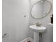 Powder room featuring pedestal sink and decorative mirror at 149 E Muriel St, Orlando, FL 32806