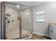 Bathroom with a large glass shower, beige tile, and a window letting in natural light at 149 E Muriel St, Orlando, FL 32806