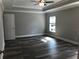 Spacious bedroom with hardwood floors, a ceiling fan, and ample closet space at 149 E Muriel St, Orlando, FL 32806