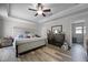 Bedroom with a upholstered bed frame, wood-look floors, and crown molding at 149 E Muriel St, Orlando, FL 32806