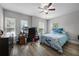 Bedroom with blue bedding, grey walls, and wood-look floors at 149 E Muriel St, Orlando, FL 32806