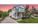 Charming two-story home with a manicured front lawn, brick driveway, and inviting front porch at 149 E Muriel St, Orlando, FL 32806