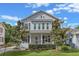 Charming two-story home with manicured front lawn, landscaping and colorful prayer flags at 149 E Muriel St, Orlando, FL 32806