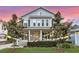 Charming two-story home with manicured front lawn, landscaping and colorful prayer flags at 149 E Muriel St, Orlando, FL 32806
