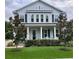 Charming two-story home featuring a welcoming front porch, manicured lawn and classic architectural details at 149 E Muriel St, Orlando, FL 32806