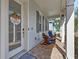 Inviting front porch with rocking chairs, brick flooring, and a view of the neighborhood at 149 E Muriel St, Orlando, FL 32806