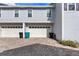 Two-car garage with white doors and a brick driveway; well-maintained exterior at 149 E Muriel St, Orlando, FL 32806