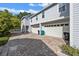 Two-car garage with white doors and a brick driveway; well-maintained exterior at 149 E Muriel St, Orlando, FL 32806