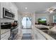 Bright kitchen featuring granite countertops, stainless appliances, and access to the patio at 149 E Muriel St, Orlando, FL 32806