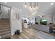 Open concept living space with modern lighting, hardwood floors, and stainless steel appliances at 149 E Muriel St, Orlando, FL 32806