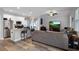 Open-concept kitchen and living room area with stainless steel appliances and hardwood floors at 149 E Muriel St, Orlando, FL 32806