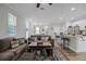 Open-concept living room with a large sofa and a kitchen featuring stainless steel appliances at 149 E Muriel St, Orlando, FL 32806