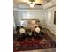 Cozy main bedroom with a ceiling fan, tray ceiling, large rug and accent chairs at 149 E Muriel St, Orlando, FL 32806