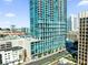 High-rise building with blue-tinted windows, balconies, and a street view, reflecting modern architecture at 150 E Robinson St # 209, Orlando, FL 32801