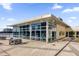 Exterior view of fitness center features large windows, tables and chairs, and a paved patio area at 150 E Robinson St # 209, Orlando, FL 32801