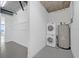 Laundry area with washer, dryer and water heater, along with some shelving at 150 E Robinson St # 209, Orlando, FL 32801