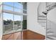 Living room showcasing the spiral staircase, hardwood floors and exterior balcony at 150 E Robinson St # 209, Orlando, FL 32801