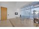 Stylish lounge area with chairs, a glass coffee table, a television, and natural light through sheer curtains at 150 E Robinson St # 209, Orlando, FL 32801