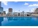 Rooftop swimming pool offers cabanas with lounge seating and clear blue water, set against the urban skyline at 150 E Robinson St # 209, Orlando, FL 32801