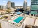 Stunning rooftop pool with city views, lounge chairs, and tennis court providing an urban oasis at 150 E Robinson St # 209, Orlando, FL 32801