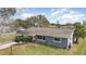 Aerial view highlighting the front of the home, mature landscaping and long driveway at 1503 Wisconsin Ave, St Cloud, FL 34769