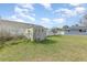 Backyard featuring a storage shed on a grassy lot with partial fencing around the property at 1503 Wisconsin Ave, St Cloud, FL 34769