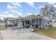 Backyard featuring a covered patio, table and chairs, and an external storage shelf at 1503 Wisconsin Ave, St Cloud, FL 34769