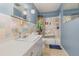 Bathroom featuring blue walls, a vanity with ample counter space, and a shower/tub with safety features at 1503 Wisconsin Ave, St Cloud, FL 34769