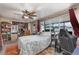 Bedroom with hard surface floors, ceiling fan, and a large window bringing in plenty of natural light at 1503 Wisconsin Ave, St Cloud, FL 34769