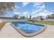 Backyard featuring a pool with a cement perimeter, a shed, and a white fence at 1503 Wisconsin Ave, St Cloud, FL 34769