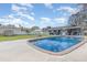 Backyard pool with a brick trim and ample concrete decking space, along with a grassy yard at 1503 Wisconsin Ave, St Cloud, FL 34769