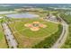 An aerial shot showcases the baseball fields and the community with a view of a lake at 1546 Park Leah Cir, Apopka, FL 32712