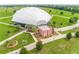 Exterior view of the Apopka Amphitheater and grounds, with lush lawns, palm trees, and a white canopy at 1546 Park Leah Cir, Apopka, FL 32712