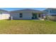 Home exterior showing the backyard, patio, and lush green lawn at 1546 Park Leah Cir, Apopka, FL 32712