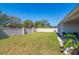 Landscaped backyard with green grass and white fencing, offering a serene outdoor space at 1546 Park Leah Cir, Apopka, FL 32712