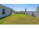 A spacious backyard with a lush green lawn and a tall privacy fence for added seclusion at 1546 Park Leah Cir, Apopka, FL 32712