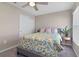 Bedroom with a bed, decorative bedding, and a ceiling fan, accented by a modern end table and houseplant at 1546 Park Leah Cir, Apopka, FL 32712