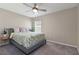 Simple bedroom with a bed, a ceiling fan, neutral walls, and a window letting in natural light at 1546 Park Leah Cir, Apopka, FL 32712