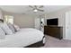 Cozy bedroom featuring a spacious bed, a ceiling fan, and a wooden dresser with a television on top at 1546 Park Leah Cir, Apopka, FL 32712