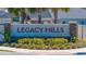 The Legacy Hills community sign is surrounded by lush landscaping at 1546 Park Leah Cir, Apopka, FL 32712