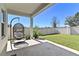 Covered patio featuring a hanging chair and potted plants overlooking the fenced backyard at 1546 Park Leah Cir, Apopka, FL 32712