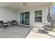 View of the covered patio featuring a hanging chair, table and chair set, and sliding glass doors at 1546 Park Leah Cir, Apopka, FL 32712