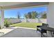 Covered patio showing a table and chair overlooking a well-maintained lawn and fenced yard at 1546 Park Leah Cir, Apopka, FL 32712