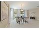 Dining area with bright natural light, modern chandelier, and neutral color scheme at 1546 Park Leah Cir, Apopka, FL 32712