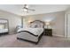 Serene main bedroom with neutral colors, cozy carpet, ceiling fan, and ample natural light at 1546 Park Leah Cir, Apopka, FL 32712