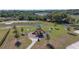 Community playground surrounded by benches, picnic tables, and lush green space with mature trees at 1546 Park Leah Cir, Apopka, FL 32712